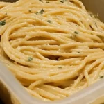 Easy Butter Garlic Spaghetti in a skillet with garlic flakes