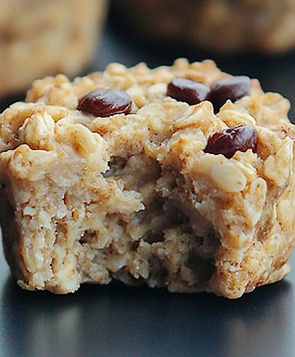Close-up of a soft and chewy breakfast oatmeal cupcake with a bite taken out