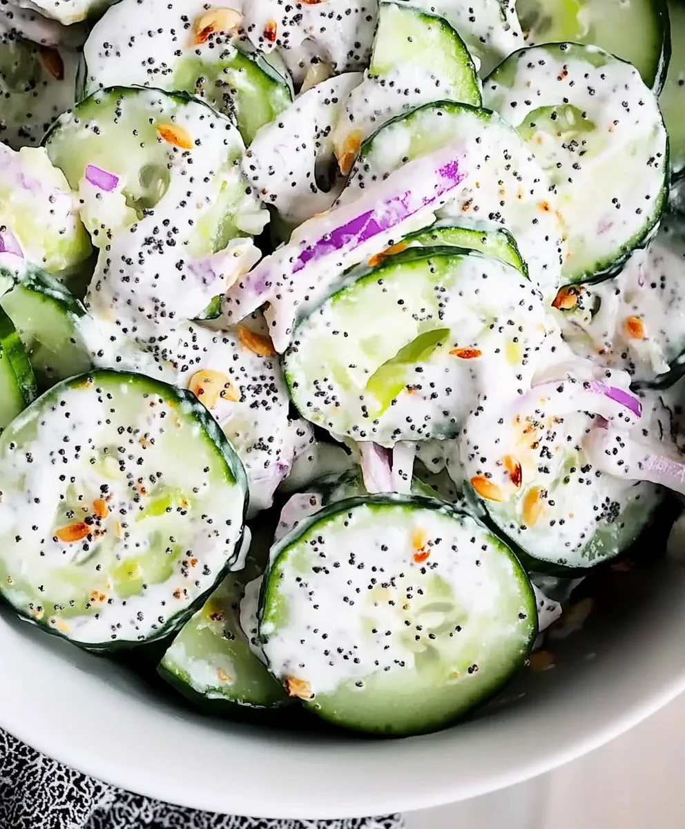 Everything bagel cucumber salad preparation with sour cream dressing